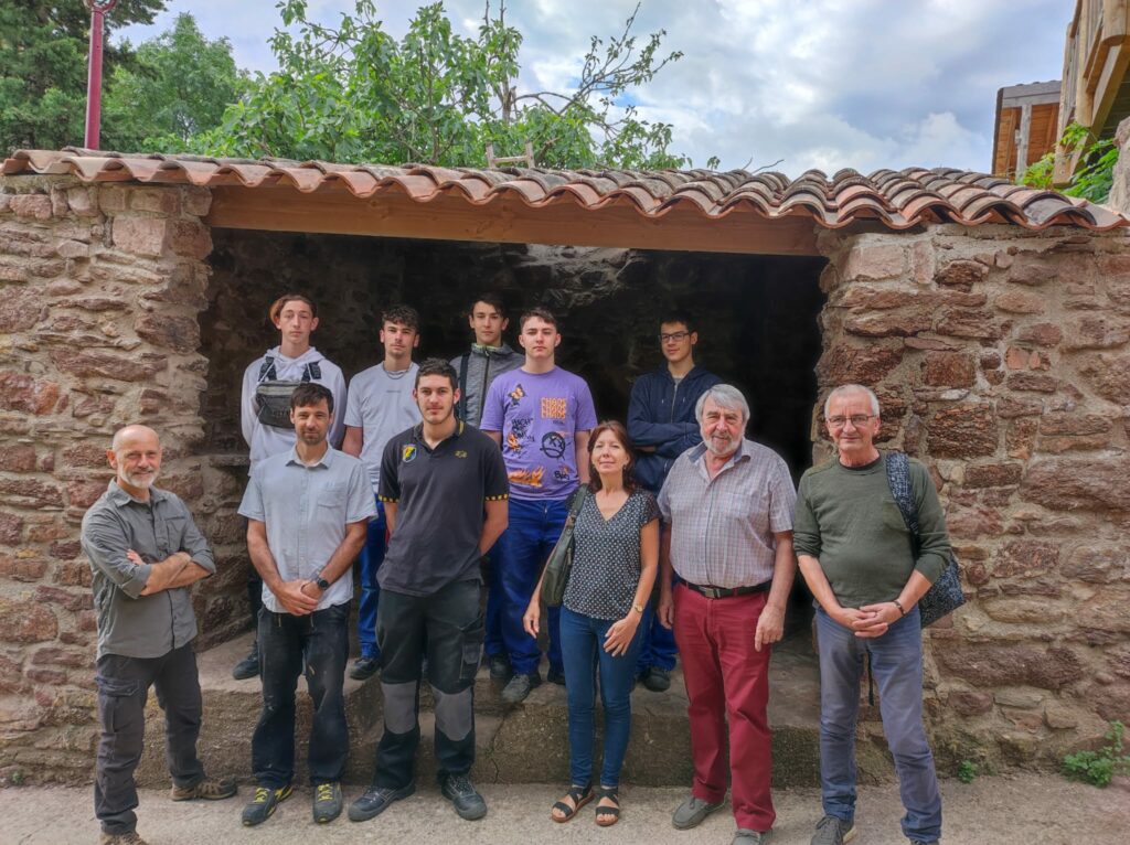 Un groupe 11 personnes (dont 7 adolescents se tiennent debout et pose pour la photo devant le fournil du four à pain de Frangouille